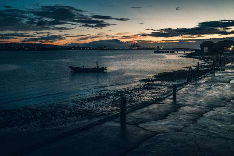Color picture of a boat in Tamsui river's shore at dusk in Taipei, Taiwan.