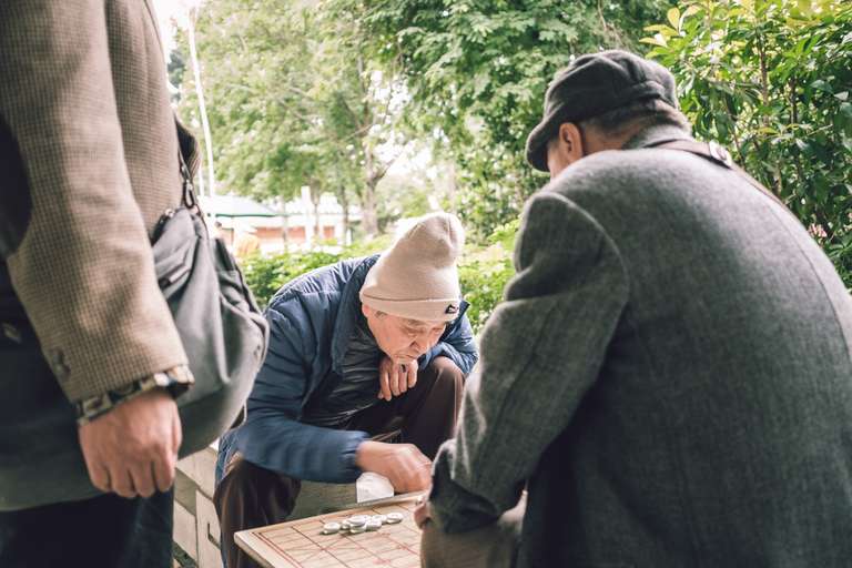 Color street photography. A picture of a couple of old men playing Chinese chess in CKS memorial park in Taipei, Taiwan.