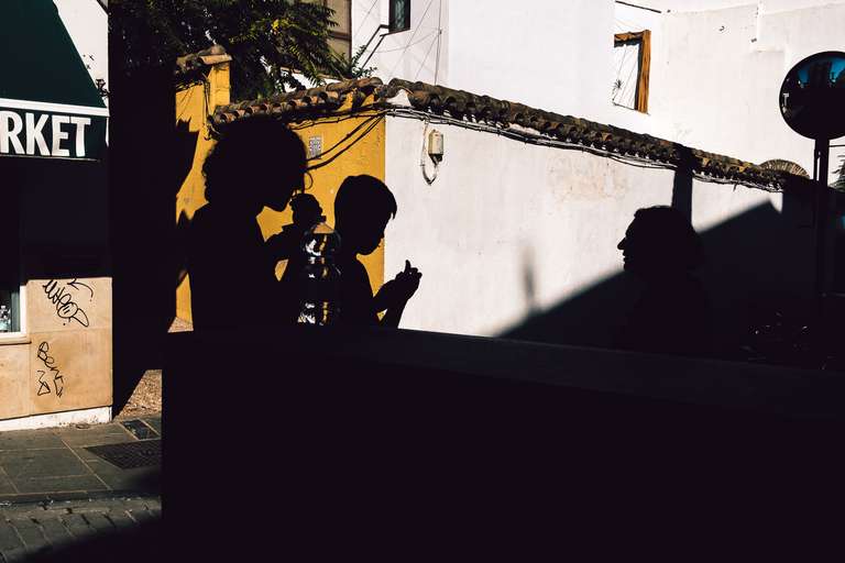 Color street photography. A picture of a group of kids silhouette in Cordoba, Spain.