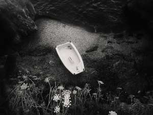 Black and white street photography, a picture of a tiny boat on a cove in Toulon, south of France.